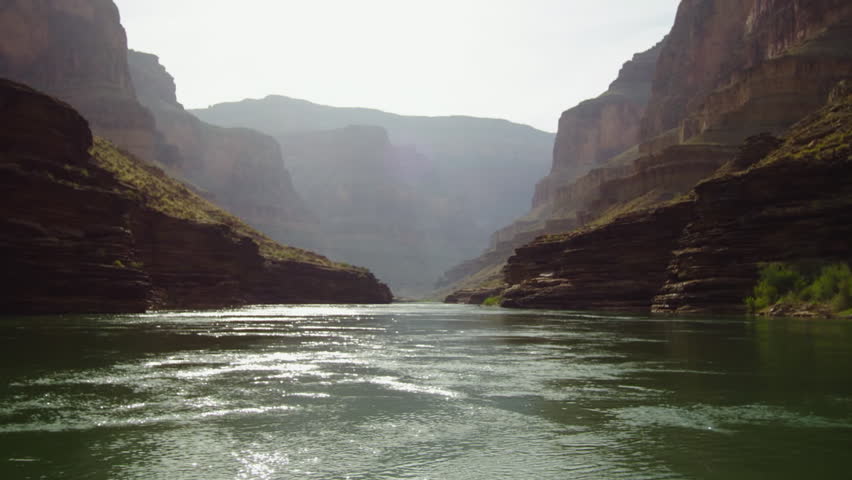 POV shot while rafting on the Colorado River through the majestic and sunny Grand Canyon