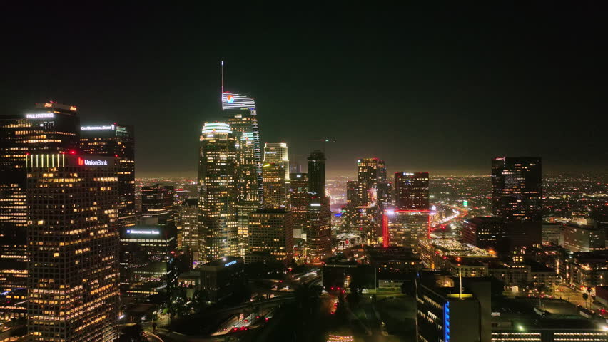 Los Angeles night aerial motion. Downtown Los Angeles lights. Los Angeles at night panorama. Los Angeles city skyline at night.