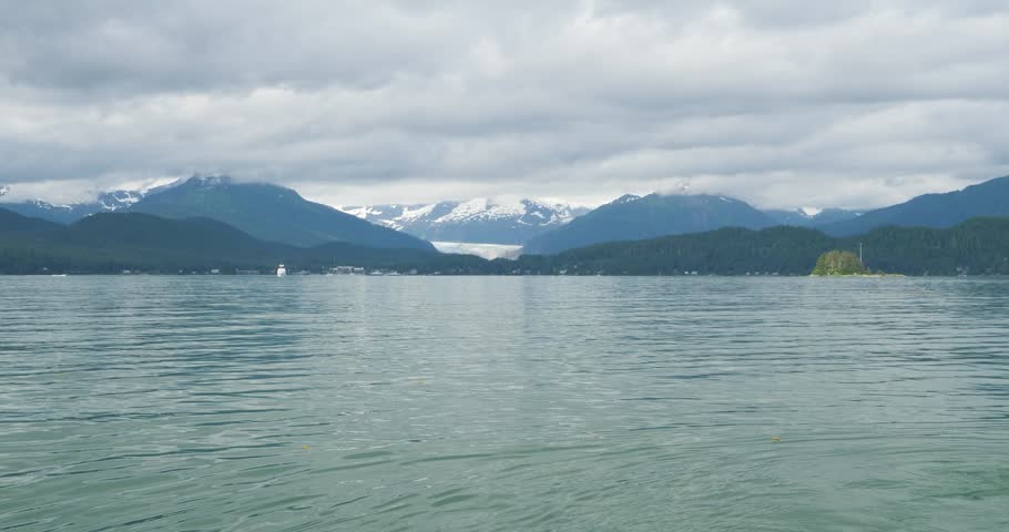 Mendenhall Glacier and the surrounding mountains covered by clouds, Alaska.