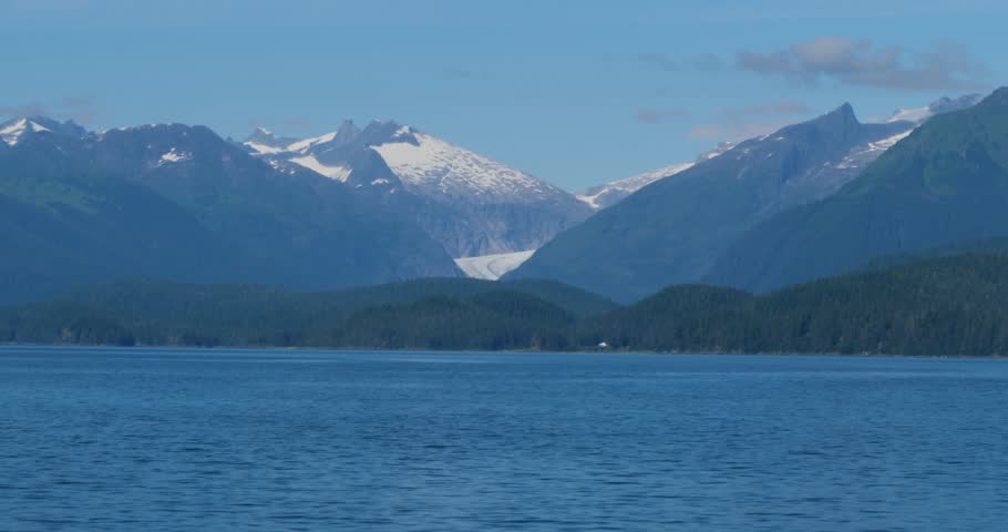 Sailing out from Juneau, Alaska, in a sunny day.Mendenhall Glacier and the surrounding mountains in the background.