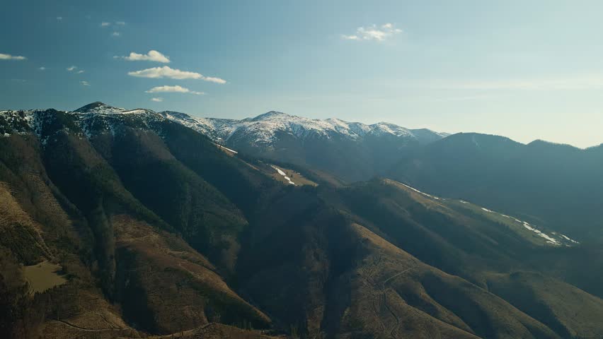 Sunny Mountain Scenery. Bright Sunlight Illuminates Serene Mountain Ridges And Peaceful Valleys With Warmth