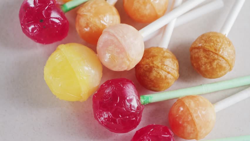 Bright colorful candies, lollipops on a white background rotating close-up. High quality 4k footage