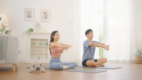 Asian couple practicing yoga class exercise together in living room at home, healthy wellness lifestyle fitness routine, stretching and balance poses, indoor workout for flexibility strength relaxation and mindfulness training - Powered by Shutterstock - Get 15% off with code: PIKWIZARD15