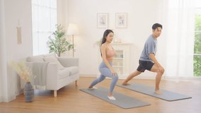 Asian couple practicing yoga class exercise together in living room at home, healthy wellness lifestyle fitness routine, stretching and balance poses, indoor workout for flexibility strength relaxation and mindfulness training - Powered by Shutterstock - Get 15% off with code: PIKWIZARD15