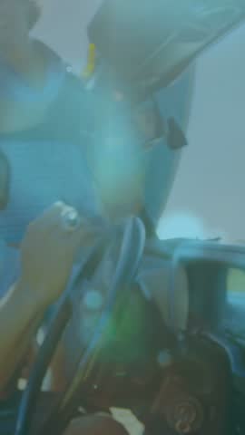 Vertical video: Friends leaning into jeep, camera tap causing sun flare lighting faces for travel. Outdoor, roadtrip, convertible, summer, candid, lifestyle, vertical video