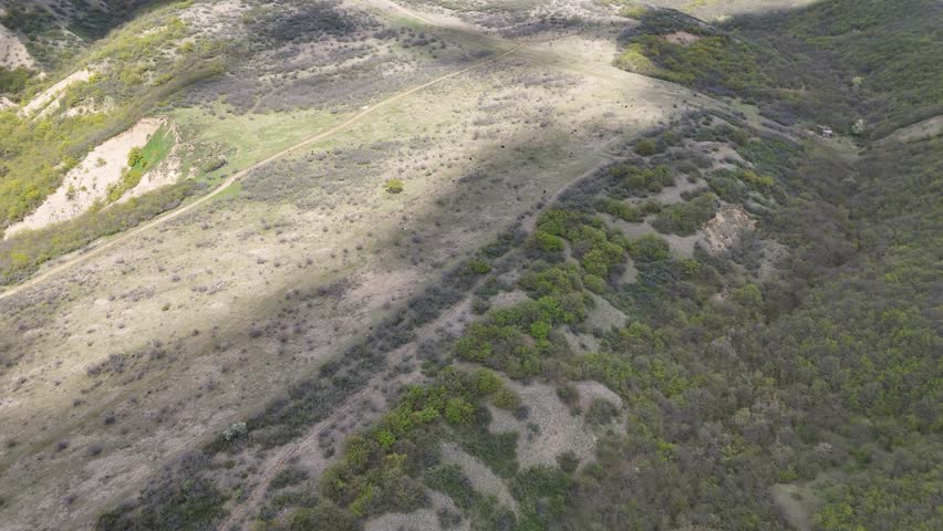 areal footage of lanscape and view of city