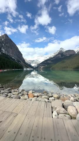 Woman hiker admiring Lake Louise in Banff National Park, Canada