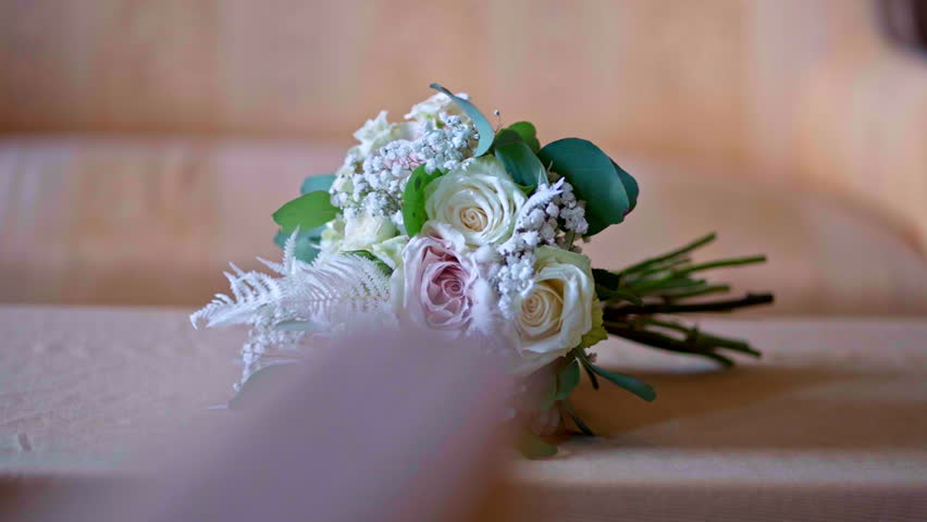 Elegant bouquet of mixed flowers on soft fabric in natural light