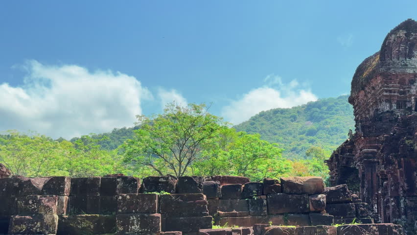 Ancient ruins at My Son Sanctuary with lush green backdrop