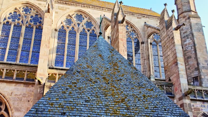 Low angle shot of bell tower and stained glass windows of Saint-Vincent Cathedral against clear blue sky in France