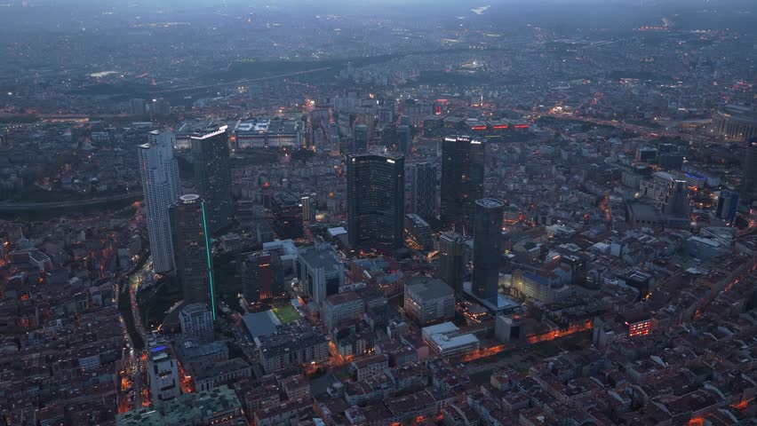 Istanbul metropolitan cityscape showing urban business districts, illuminated streets, residential areas in Turkiye, with modern skyscrapers defining skyline at twilight