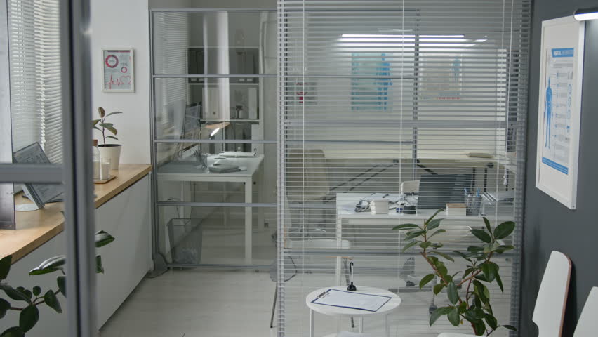 No people shot of chairs standing in waiting area of modern clinic decorated with plants