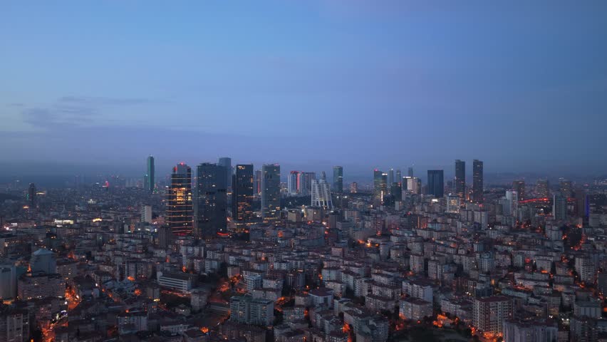Luminous metropolis of Istanbul with bustling cityscape and financial district skyscrapers illuminated at dusk, revealing urban sprawl and modern architecture of Turkey
