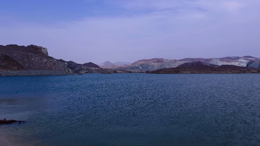 View of the sea and mountains. Scenic shot of a lake and a mountain in the background at sunrise. 