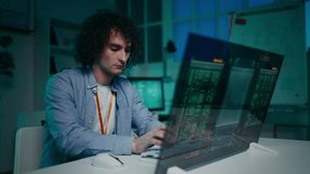 Young male developer writing complex code on holographic screen interface - Powered by Shutterstock - Get 15% off with code: PIKWIZARD15
