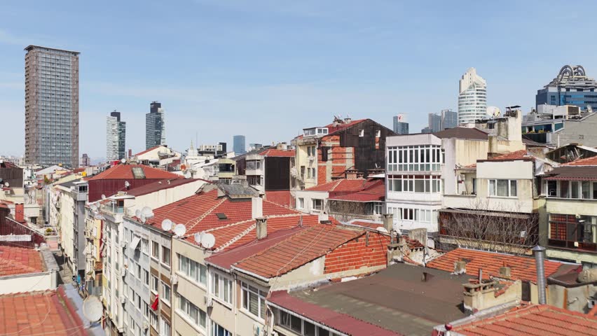 Istanbul Turkey cityscape with old residential houses revealing Sili street traffic, mosque, modern financial district skyline with skyscrapers