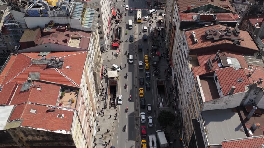 High angle of urban traffic moving along bustling street canyon in metropolitan downtown of Istanbul, Turkey, showcasing vibrant city life and architecture