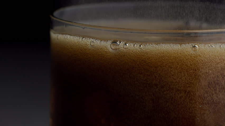 Video of cold cola with ice cubes in 4K