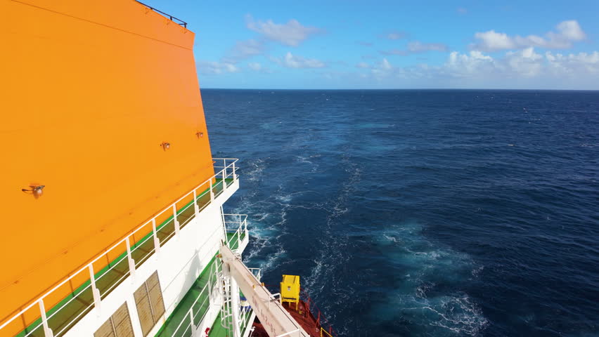 Large oil tanker in the open sea under a bright sunny sky.