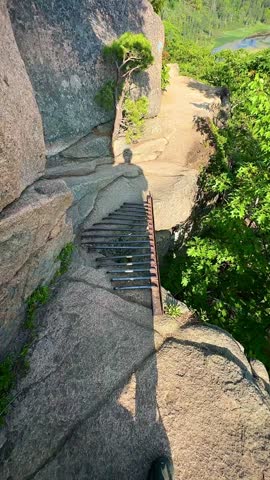 Point of View Crossing an Iron Rung Ladder on a Cliff (Acadia National Park, Maine, USA)