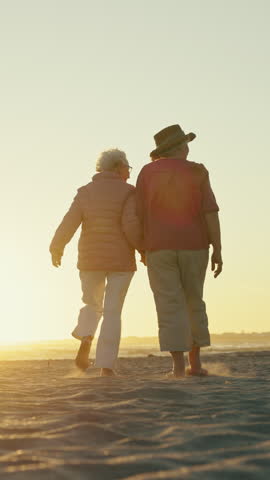 Walking, sunset and elderly people holding hands on beach, retirement tourism and windy travel holiday. Space, back or senior women with friends vacation for support, sea breeze or flare for bonding