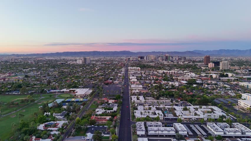 Aerial view of North 7th Street stretching towards the downtown skyline under a dawn sky, Phoenix, Arizona, United States.