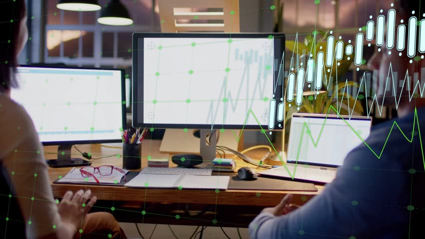 Two colleagues analyzing financial data at desk, candlestick charts appearing and guiding review. Office, collaboration, teamwork, displays, analytics, trading, openplan
