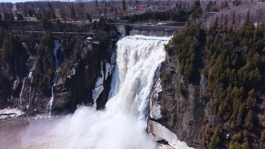 scenic canadian waterfall flowing over cliffs with surrounding forest