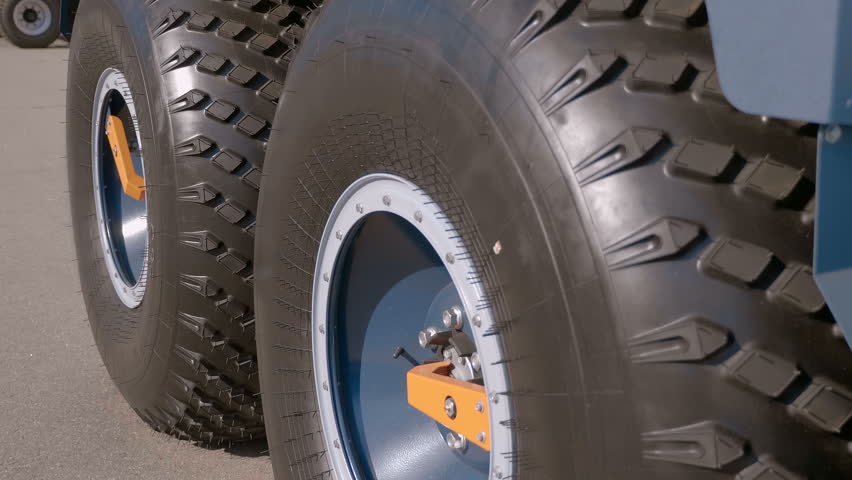 Large new all-terrain vehicle wheels with centralized automatic air inflation. Closeup. Shot in motion 