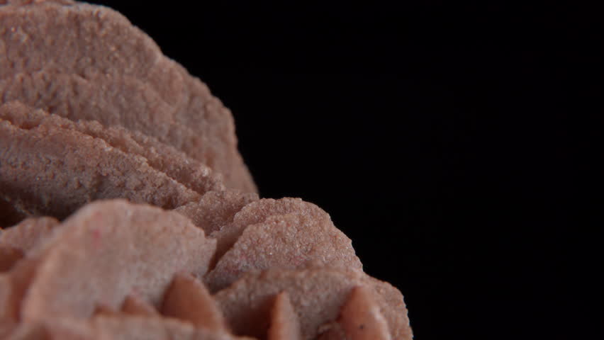 A macro of desert rose crystal or sand rose (a rose-like formations of crystal clusters of gypsum and sand grains)� isolated on a black background