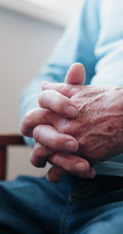 Anxiety, hands and senior man on sofa in home with nervous, stress or mental health in living room. Retirement, comfort and elderly male person with depression, worry or regret in house with mistake.