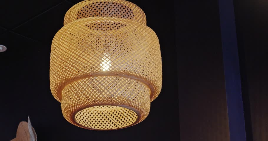 Tiered woven bamboo pendant lamp with warm interior glow