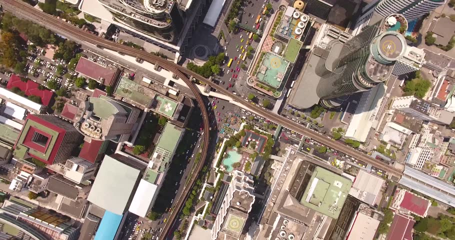 Top view of city streets and buildings from high altitude.