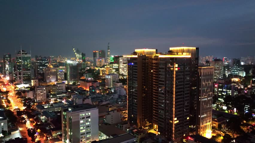 Aerial Night View of Ho Chi Minh City Skyline – Vibrant Urban Lights and Traffic in Downtown Saigon