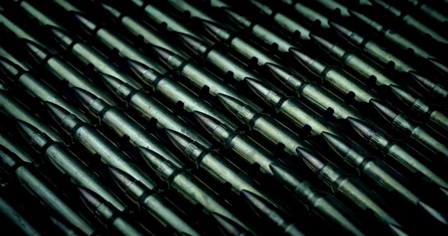 bullets lined isolated. 4k rifle ammo on dark background seamless loopable black gun crime military target war