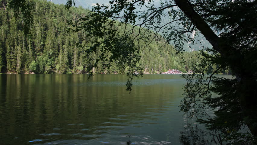 Calm lake Piburger See in Austrian Alps with lush forest and mountain slopes scenic nature landscape and tourism in Europe