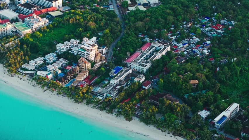 Sunrise shot Boracay Philippines coastline with hotels trees and turquoise water