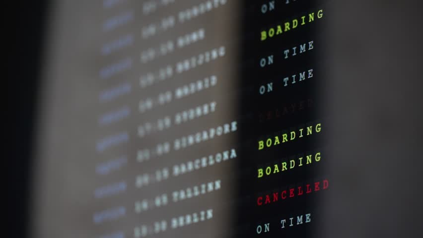 Airport flight information board with departures timetable.