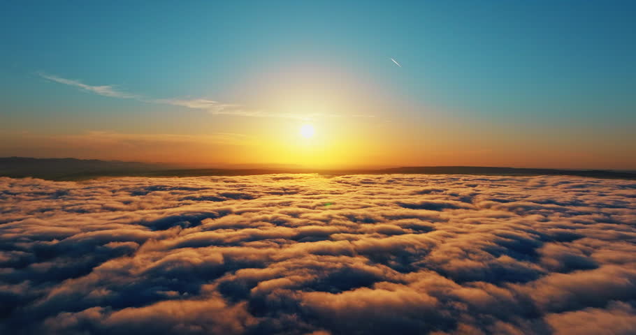 Golden hour sunset over cloudscape aerial view. High altitude drone flight sun shining blue sky. Summer travel destination exploration nature landscape scenic background high angle.