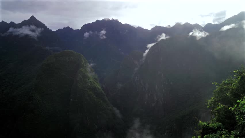 Machu Picchu Pueblo lookout Peruvian Andres highlands jungle Mountains Aguas Calientes Peru landscape early morning sunrise fog layer clouds Inca Trail Temple Vilcanota Urubamba River static shot