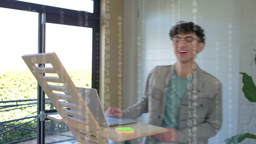 Hologram appearing denim man leaning, beanie typing, woman pointing at meeting table, collaborating. Collaboration, teamwork, boardroom, laptops, modern, holographic, ui