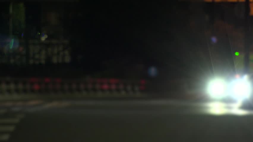 TOKYO, JAPAN : View of street traffic at night. Many cars passing on busy road in the downtown area. Transportation, urban traffic and night road concept time lapse shot.