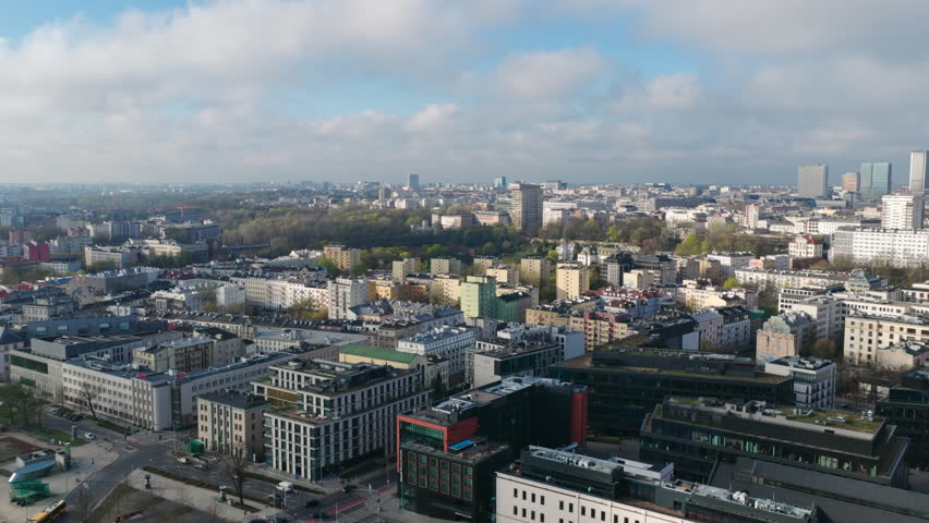 The Modern Red and Glass Building of Centrum Nauki Kopernik Sits Along the Vistula River in Warsaw, Poland - Aerial Pullback Shot