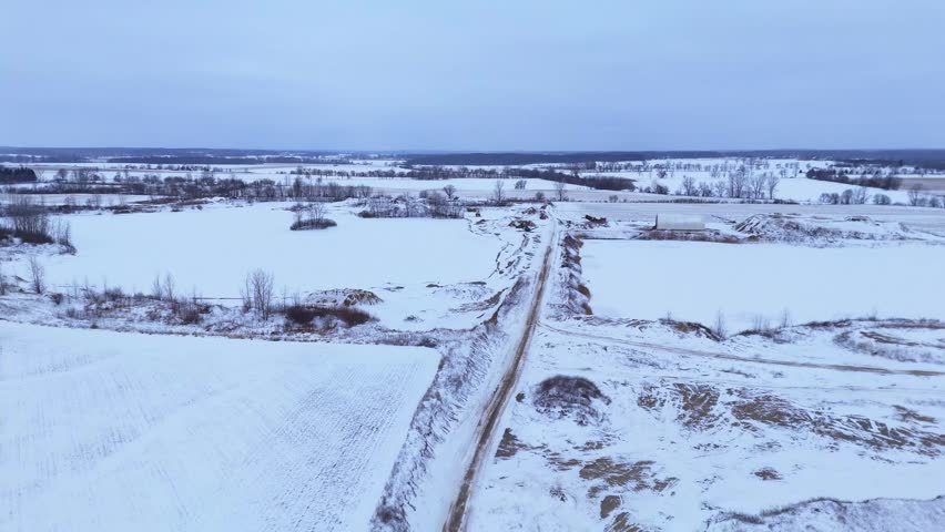 Winter landscape with road and snow-covered fields near Saline, Michigan