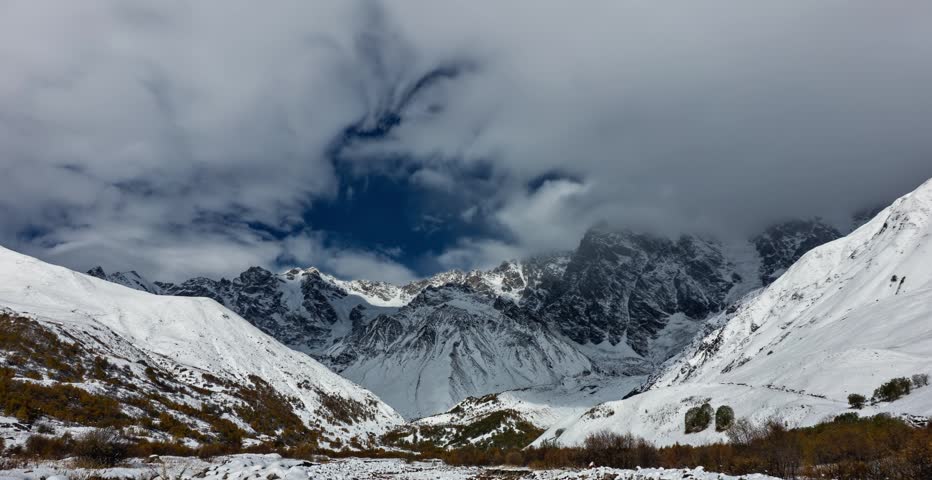 Dramatic Clouds Forming Over Snowy Caucasus Mountains in Winter Nature Time lapse