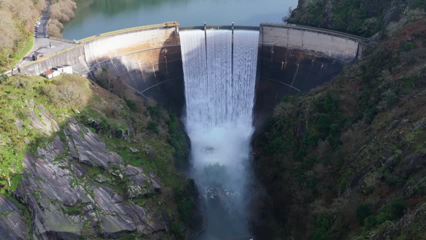 Encoro do Eume In Galicia, Spain - Massive Concrete Dam Releasing Powerful Torrent Of Water Into Misty Canyon. wide drone shot