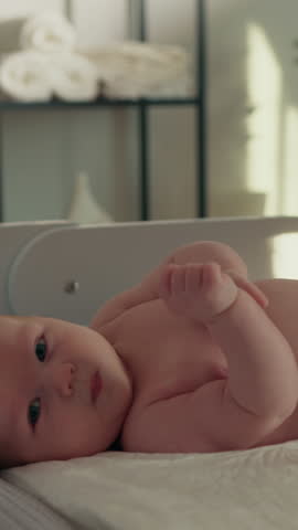 Close-up of a peaceful newborn baby sleeping soundly in a crib, showing delicate features and tiny hands