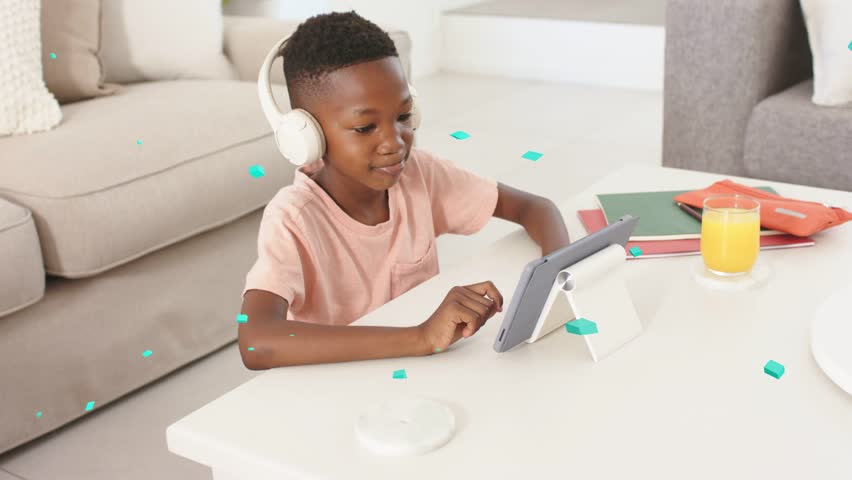Child tapping tablet at table causing animated teal graphics floating around child for education. Kid, student, headphones, device, learning, focus, home