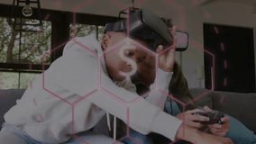 Two teens alternating, putting on headset and starting VR gaming, pink dollar HUD overlaying scene. Duo, friends, couch, livingroom, multiplayer, play, candid - Powered by Shutterstock - Get 15% off with code: PIKWIZARD15