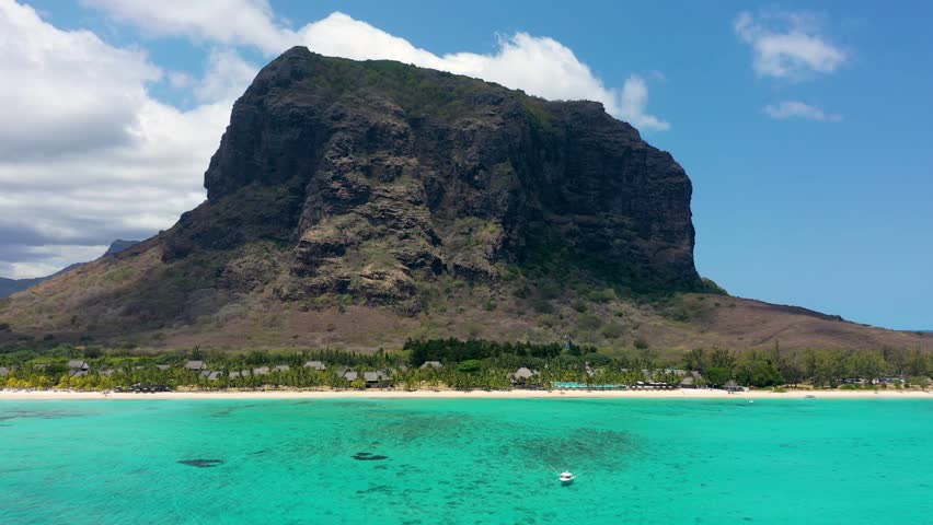 Aerial view of Le morne Brabant in Mauriutius. Tropical crystal ocean with Le Morne mountain and luxury beach in Mauritius. Le Morne beach with palm trees, white sand and luxury resorts, Mauritius.